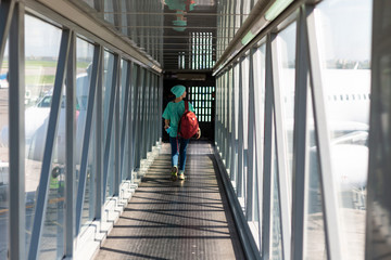 Young woman in the boarding bridge in the airport