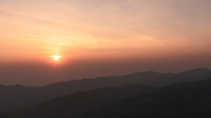sunset time with gradiant colorful sky and mountain range
