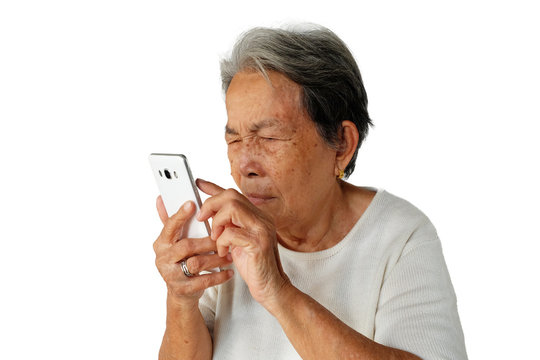Elderly asian woman are holding and looking mobile phone with poor eyesight isolated on white background, Hyperopia or Poor eyesight concept