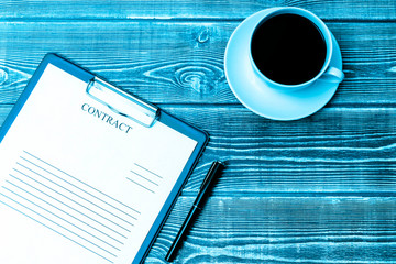 Contract, pen, coffee Cup on wooden table background. business, Finance, contract signing.