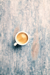 Cup of coffee on rustic wooden background. Top view. Copy space.