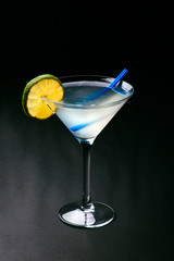 Classic Daiquiri cocktail with lime in martini glass on a dark background. Space for text.