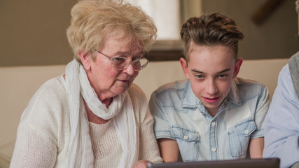 Short sighted grandmother cant see the grandchild laptop