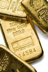 Several cast gold bars of different weight on a white background.