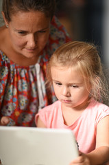 mother and child looking at a tablet