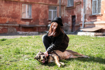 girl with a dog near the wall