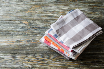 Stack of kitchen towels or napkins over the rustic wooden table.