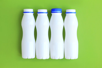 white plastic bottles on a green background the concept of respect for nature and the rejection of the use of plastic