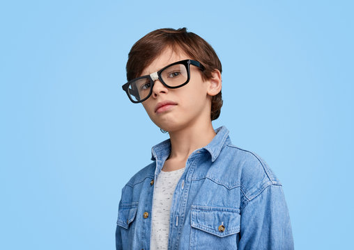Little smart boy in broken glasses