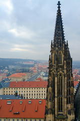 Obraz premium Gothic stone tower of St. Vitus Cathedral on background of city, Prague, Czech Republic
