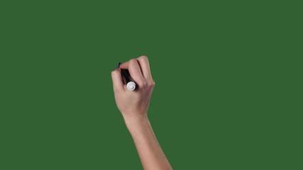Green screen. Chromakey. Female right hand writes a marker on the wall.