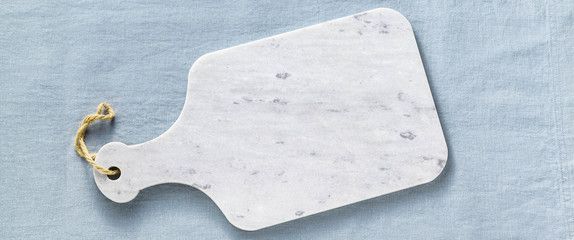 marble cutting board obanner of marble cutting board on a blue linen tablecloth. empty form for...