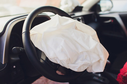 Interior Of A Automobile Or Car Involved In A Vehicle Crash With A Deployed Steering Column Airbag.