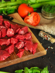 raw meat sliced, cut pieces on a cutting board, fresh. top view. food background