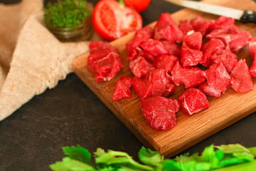 raw meat sliced, cut pieces on a cutting board, fresh. top view. food background
