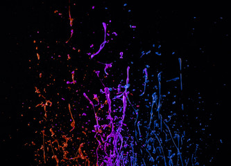 Macro photo of mixed acryl colors on black