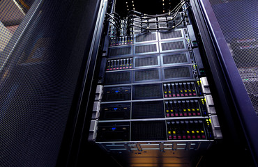 Close up cloud storage system panel modern with hard drives. Detail interior rack cluster in data center.