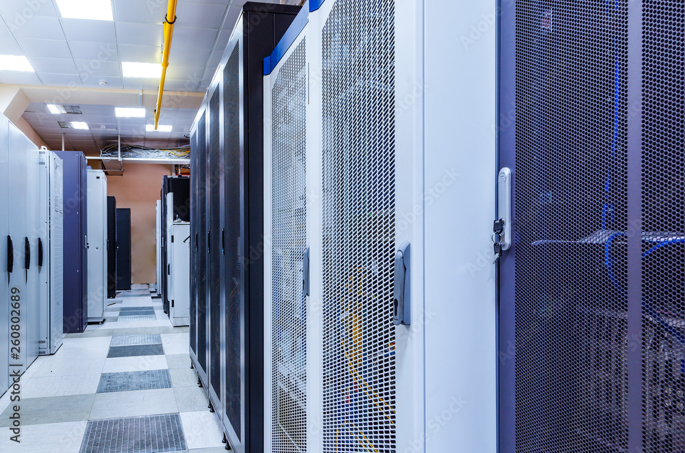 Poster room with rows of server hardware in big modern data center corridor. technical equipment and superc