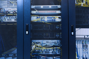 Technical wall of cellular data terminal in modern communication center. Close up backhaul network...