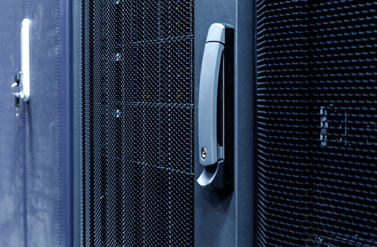 Technological background with close up grid closed doors in data center. - Powered by Adobe