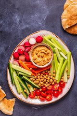 Hummus with various fresh raw vegetables.