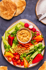 Hummus with various fresh raw vegetables.
