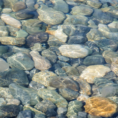 Background of sea colored stones under water.