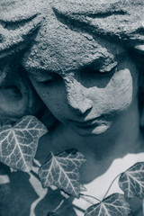 Death. Sad angel as symbol of pain, fear and end of life. Ancient stone statue.
