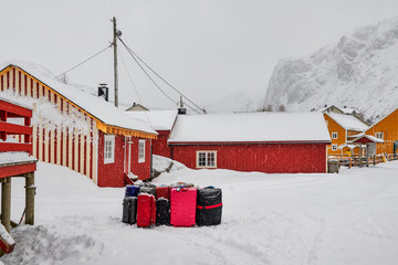 Naklejka premium Norway winter, Lofoten islands, Nusfjord, suitcases waiting for transport