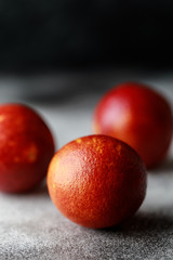 Fresh ripe red oranges on dark background. Healthy orange fruits background many orange fruits. 