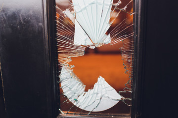 Broken glass black door of the shop.