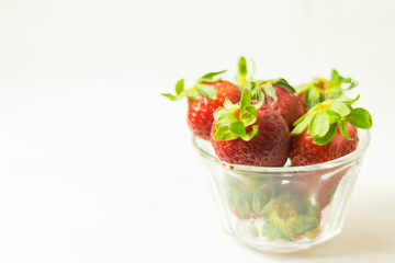 strawberries in a bowl isolated on white background