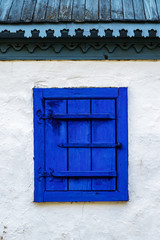 Blue wooden window on white house