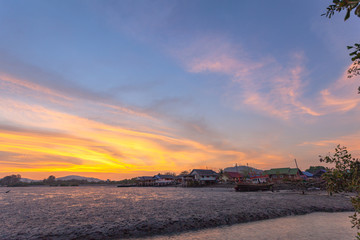 stunning sunset at fishing village in Phuket.during low tide will has a small canal beside fishing village..