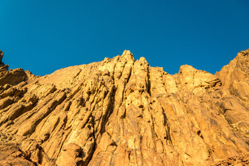 Fototapeta premium Middle East or Africa, picturesque bare mountain range and a large sandy valley desert landscapes landscape photography