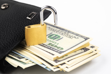 Business safety or financial protection or allow access. Heap of money in chain with open padlock isolated on white