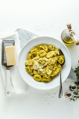 plate of italian cooked ravioli tortellini with parmesan cheese on the table. healthy Mediterranean food