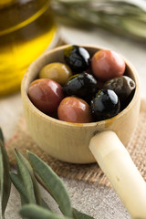 Olives in wooden spoon