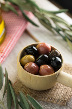 Close up olives and olive oil leaves.