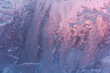 texture background frosty pattern pink. Texture of frost patterns. Winter frosty purple patterns on...