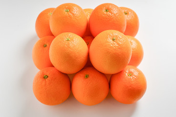 Pyramid of Oranges isolated on white background.