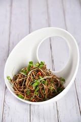 green tea leaves in a bowl on white background