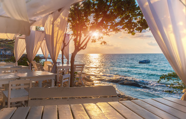 Island blue sea view with white decorataion relax place with sunrise lighting.