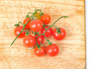 Small Tomato on wood background.Food concept.