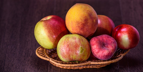 Still life of peaches and juice on a dark background