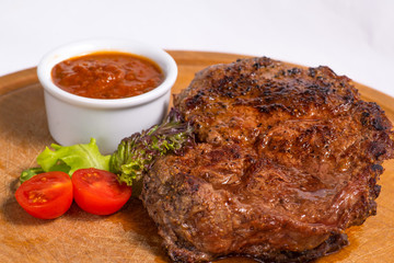 fried steak and serving with vegetables on a cutting board