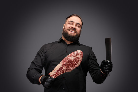 Cheerful butcher with knife and meat