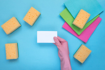 Cleaning set for different surfaces in kitchen, bathroom and other rooms. Empty place for text or logo on blue background. Cleaning service concept. Early spring regular clean up. Top view.Flat lay