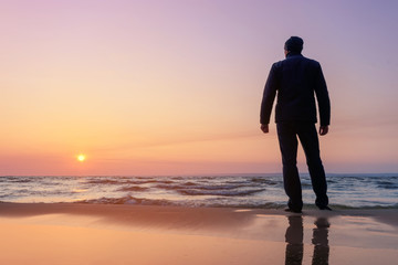 silhouette of a man at dawn / beach wilderness dawn