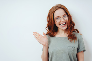 Cute young woman pointing to copyspace